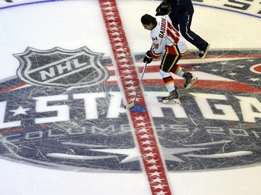 Calgary Flames' Johnny Gaudreau (13) of Team Toews, takes the puck at center ice during the breakaway competition at the NHL All-Star hockey skills competition in Columbus, Ohio, Saturday, Jan. 24, 2015.
