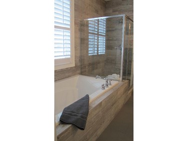 The soaker tub and shower in the Huxley II by Cedarglen Homes in Riverstone of Cranston.