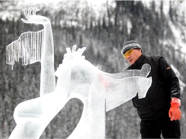 A member of Team Sakha Russia, who spoke no English, crafts the Northern Fire Dance of the Sky on the shore of Lake Louise Saturday January 17, 2015 at the Ice Magic Festival. The sculpture was part of the International Ice Carving Competition in which 10 internationally accredited teams of 2 are given 15 blocks of ice and 34 hours to create a frozen masterpiece using the theme Wonders of the World.