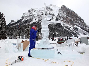 Sculptor Edith Van de Wetering  works in details on Aurora, her personification of the Northern Lights, on Day Two of the Ice Magic Festival on the shore of Lake Louise Saturday January 17, 2015. She was on Team Double Dutch Trouble from the Netherlands. Her sculpture was part of the International Ice Carving Competition in which 10 internationally accredited teams of 2 are given 15 blocks of ice and 34 hours to create a frozen masterpiece using the theme Wonders of the World.