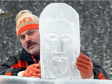 Zareh Nercissian of Team Ararat places the face of Jesus onto their Christ the Redeemer sculpture at the Ice magic Festival on the shore of Lake Louise Saturday January 17, 2015 at the Ice Magic Festival. The sculpture was part of the International Ice Carving Competition in which 10 internationally accredited teams of 2 are given 15 blocks of ice and 34 hours to create a frozen masterpiece using the theme Wonders of the World.