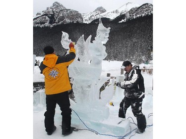 Thai sculptors Kla Kitburi, right, and his brother Chan, now living in Seattle, fine tune tune their creation, Siamese Kinaree at the Ice Magic Festival on the shore of Lake Louise Saturday January 17, 2015 at the Ice Magic Festival. The sculpture was part of the International Ice Carving Competition in which 10 internationally accredited teams of 2 are given 15 blocks of ice and 34 hours to create a frozen masterpiece using the theme Wonders of the World.