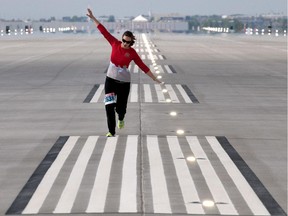 Louise Robinson imitates an airplane as she warms up prior to a public run to celebrate the opening of the new runway at the airport last June. Reader thinks it was built in the wrong direction.