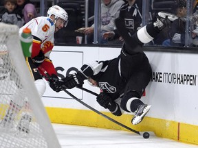 Los Angeles Kings right wing Marian Gaborik, right, of Slovakia, falls as he battles for the puck with Calgary Flames defenseman Mark Giordano during the second period of an NHL hockey game, Monday, Dec. 22, 2014, in Los Angeles.