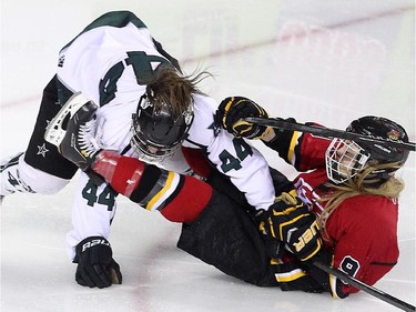 Calgary Fire defenceman Isabel Johnson, right, and Saskatoon Stars forward Jordyn Holmes slid to the ice during the Max's AAA Midget Tournament female final at the Scotiabank Saddledome on January 1, 2015. The Stars defeated the Fire 4-2 to claim the cup.