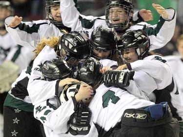 Members of the Saskatoon Stars crowded around goalie Karlee Fetch after defeating the Calgary Fire in the Max's AAA Midget Tournament female final at the Scotiabank Saddledome on January 1, 2015. The Stars defeated the Fire 4-2 to claim the cup.