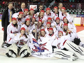 Members of the Saskatoon Stars huddled around the cup after defeating the Calgary Fire during the Max's AAA Midget Tournament female final at the Scotiabank Saddledome on January 1, 2015. The Stars defeated the Fire 4-2 to claim the cup.