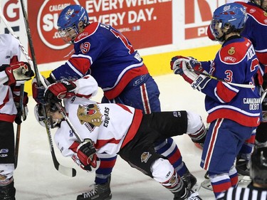 Cariboo Cougars forward Darren Hards, left, got slammed to the ice by Regina Pat Canadians forward Bryce Platt in the Max's AAA Midget Tournament male final. The Cougars took the title with a 2-1win in double overtime at the Scotiabank Saddledome on January 1, 2015.