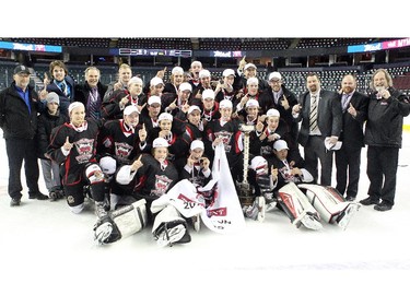 Members of the Cariboo Cougars celebrated after defeating the Regina Pat Canadians in the Max's AAA Midget Tournament male final 2-1 in double overtime at the Scotiabank Saddledome on January 1, 2015.