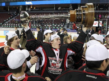 Cariboo Cougars forward Brendan Moore celebrated while holding the trophy after his team defeated the Regina Pat Canadians in the Max's AAA Midget Tournament male final 2-1 in double overtime at the Scotiabank Saddledome on January 1, 2015.