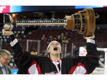 Cariboo Cougars forward Austin Gray hoisted the trophy after his team defeated the Regina Pat Canadians in the Max's AAA Midget Tournament male final 2-1 in double overtime at the Scotiabank Saddledome on January 1, 2015.
