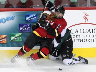Calgary Fire forward Kelsey Tangjerd tied Saskatoon Stars defenceman Paige Michalenko up along the boards during the Max's AAA Midget Tournament female final at the Scotiabank Saddledome on January 1, 2015. The Stars defeated the Fire 4-2 to claim the cup.