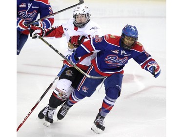 Cariboo Cougars forward Steve Jandrie, left, laid a check on Regina Pat Canadians forward Arthur Miller in the Max's AAA Midget Tournament male final. The Cougars took the title with a 2-1win in double overtime at the Scotiabank Saddledome on January 1, 2015.