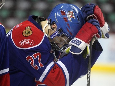 Dejected Regina Pat Canadians forward Myles Mattila stood on the blue line with teammates after their loss in the Max's AAA Midget Tournament male final 2-1 in double overtime at the Scotiabank Saddledome on January 1, 2015.