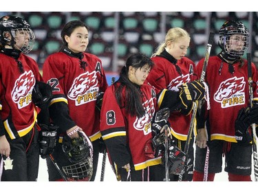 Members of the Calgary Fire watched as their opponent the Saskatoon Stars were awarded the gold medal following the Max's AAA Midget Tournament female final at the Scotiabank Saddledome on January 1, 2015. The Stars defeated the Fire 4-2 to claim the cup.