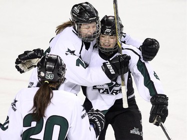 Saskatoon Stars forward Kianna Dietz, upper left, celebrated with teammate defenceman Jenna Nash, right, after the line scored the Stars first goal of the game against the Calgary Fire during the Max's AAA Midget Tournament female final at the Scotiabank Saddledome on January 1, 2015. The Stars defeated the Fire 4-2 to claim the cup.