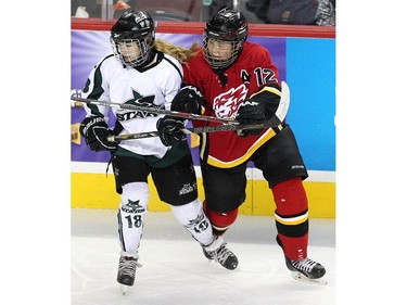 Calgary Fire defenceman Kate Mura, right, tied up Saskatoon Stars Abby Shirley during the Max's AAA Midget Tournament female final at the Scotiabank Saddledome on January 1, 2015. The Stars defeated the Fire 4-2 to claim the cup.