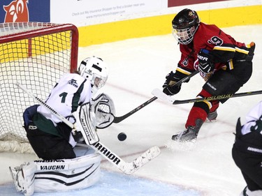 Calgary Fire forward Jaslin Sawatzky, right, looked to tip the puck past Saskatoon Stars goalie Karlee Fetch during the Max's AAA Midget Tournament female final at the Scotiabank Saddledome on January 1, 2015. The Stars defeated the Fire 4-2 to claim the cup.