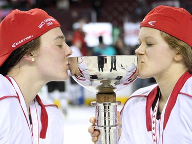 Saskatoon Stars forward Brittany Heuchert, left, and defenceman Hollie Coumont kissed the cup after winning the championship of the Max's AAA Midget Tournament female final at the Scotiabank Saddledome on January 1, 2015. The Stars defeated the Calgary Fire 4-2 to claim the cup.