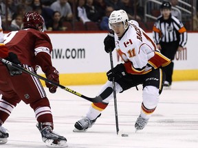 Calgary Flames centre Mikael Backlund tries to skate around Arizona Coyotes' Sam Gagner during a game last week.