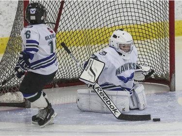 Novice Glenlake Hawks 3's goalie makes a save against Bow Valley 3 during the finals of the ESSO minor hockey week in Calgary, on January 17, 2015.