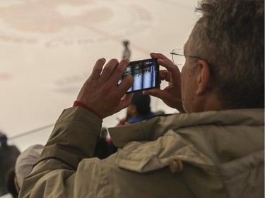 A parent record the game with his cell phone between Bow Valley Flames and the Blackfoot Chiefs during the finals of the ESSO minor hockey week in Calgary, on January 17, 2015.