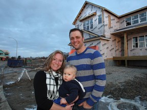 Meghan and Matt LaBarbera with son Benen, 1, at the site of their new home in Kinniburgh South, in Chestermere.