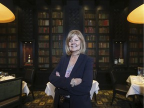 Barb Steen, Hy's Steakhouse and Cocktail Bar general manager, poses in one of the several dining area's, this one decorated with authentic vintage used books.