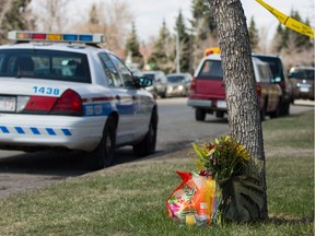 A police car stands watch over the home where Sanjula Devi and Fahmida Velji-Visram were fatally stabbed on Sunday in Calgary on Wednesday May 7, 2014.