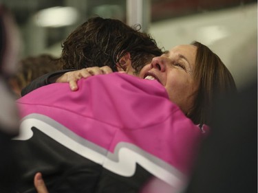 Marie Huber hugs her son, Matt Huber, of the Calgary AAA Flames after the Northwest Calgary Athletic Associationís 5th annual ìPink in the Rinkî fundraiser in Calgary, on January 17, 2015.