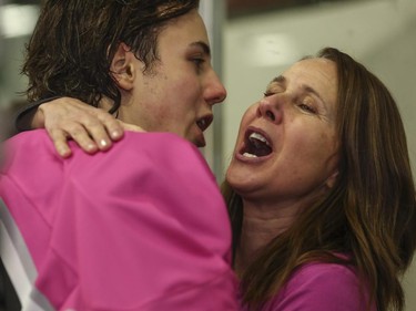 Marie Huber hugs her son, Matt Huber, of the Calgary AAA Flames after the Northwest Calgary Athletic Associationís 5th annual ìPink in the Rinkî fundraiser in Calgary, on January 17, 2015.