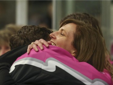 Jo Ann Riddell hugs her son, Calgary AAA Flames Jackson Riddell after the Northwest Calgary Athletic Associationís 5th annual ìPink in the Rinkî fundraiser in Calgary, on January 17, 2015.
