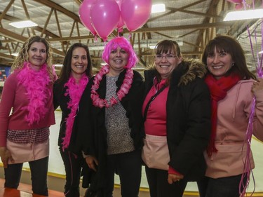 The Calgary AAA Flames' Moms, from left, Mary Monden, Kathleen Davis, Loretta Hoblak, Cindy Leong, and Leanne Fitzpatrick, deck themselves out in pink for the Northwest Calgary Athletic Associationís 5th annual ìPink in the Rinkî fundraiser in Calgary, on January 17, 2015.
