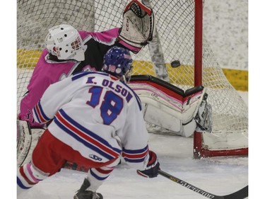 The Calgary AAA Flames' goalie, Matt Huber, can't get a glove on the shot from the Calgary Buffaloes' Keilan Olson the Northwest Calgary Athletic Association's 5th annual "Pink in the Rink" fundraiser game in Calgary, on January 17, 2015.