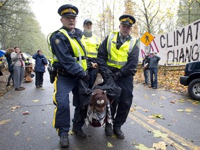 RCMP officers take protesters into custody at an anti-pipeline demonstration in Burnaby, B.C., on Nov. 20, 2014. demonstration near Vancouver.