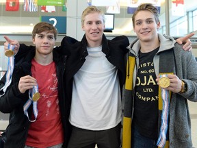 Three members of Team Canada with Calgary ties — Brayden Point, left, Dillon Hetherington and Jake Virtanen — display their gold medals at the Regina Airport after returning from the World Junior Hockey championship.