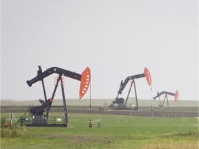 Pump jacks feed a pipeline taking the oil to the Petrobank Energy and Resources Ltd. facility in the Bakken Oil Field near Weyburn, Saskatchewan.