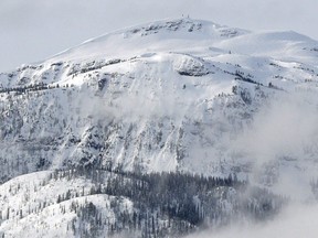 A search and rescue helicopter heads toward a deadly avalanche site in a March 2010 photo near Revelstoke, B.C.
