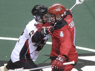 The Roughnecks Geoff Snider, right, has a little face-to-face collision against the Vancouver Stealth's Mitch McMichael during the Roughnecks home opener in Calgary, on January 3, 2015. The Roughnecks couldn't pull it together eventually succumbing to the Stealth 18 to 14.