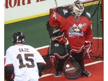 The Roughnecks goalie Mike Poulin stops a shot from Vancouver Stealth's Ilija Gajic during the Roughnecks home opener in Calgary, on January 3, 2015. The Roughnecks couldn't pull it together eventually succumbing to the Stealth 18 to 14.