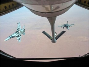 Royal Canadian Air Force CF-18 Hornets break away after refuelling over Iraq.
