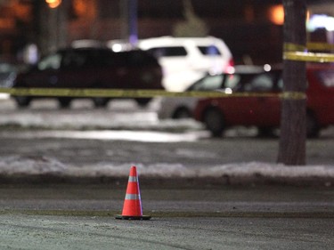 A cone sat covering a bullet casing as police investigated a shooting in the parking lot of the Village Square Co-op shopping centre on January 14, 2015.