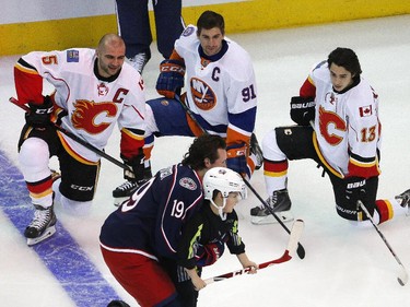 Columbus Blue Jackets' Ryan Johansen, foreground, of Team Foligno, enlists the help of a youngster to take a shot during the Breakaway competition at the NHL All-Star hockey skills competition in Columbus, Ohio, Saturday, Jan. 24, 2015. Watching are Calgary Flames' Mark Giordano (5), New York Islanders' John Tavares (91) and Calgary Flames Johnny Gaudreau (13), of Team Toews. Team Foligno won the over competition over Team Toews.