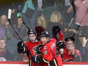 Calgary Flames Josh Jooris, left, celebrates his overtime winning goal on the Edmonton Oilers with teammate Dennis Wideman during their game at the Scotiabank Saddledome in Calgary on December 31, 2014.