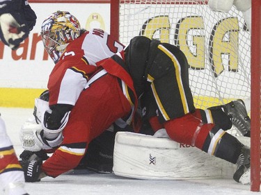 Calgary Flames centre Lance Bouma is driven to the ice by Florida Panthers goalie Al Montoya in the third period of Calgary's 6-5 loss Friday night January 10, 2015 at the Saddledome. both got penalties on the play.