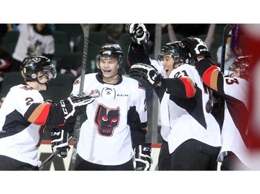 Calgary Hitmen players, from left, Jake Bean, Carson Twarynski and Terrell Draude celebrate a third period against the Edmonton Oil Kings in WHL action Saturday January 31, 2015 at the Saddledome.