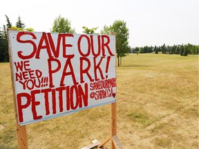 A petition sign stands in a park that is slated for a francophone school in Scenic Acres on Monday July 15, 2014.