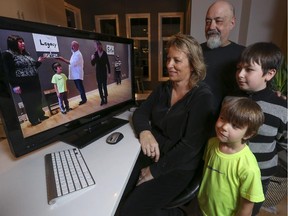 Lori O'Reilly, left, and Ron Rock, back, with their two children Rulon, right, and Dante, and many other members of the southeast community of Seton, are creating a video to argue that building a new high school should happen in their community and not in the area of Legacy, on the other side of the Bow River, in Calgary, on January 18, 2015.