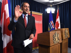 Alberta Liberal Leader Raj Sherman waves after announcing he's resigning his position as leader.