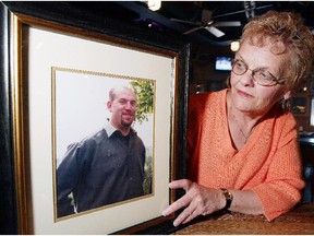 Sherry Morrison with a photo of her late son Jeff Shuckburgh, who was shot and killed by Adrian Walle in 2004.